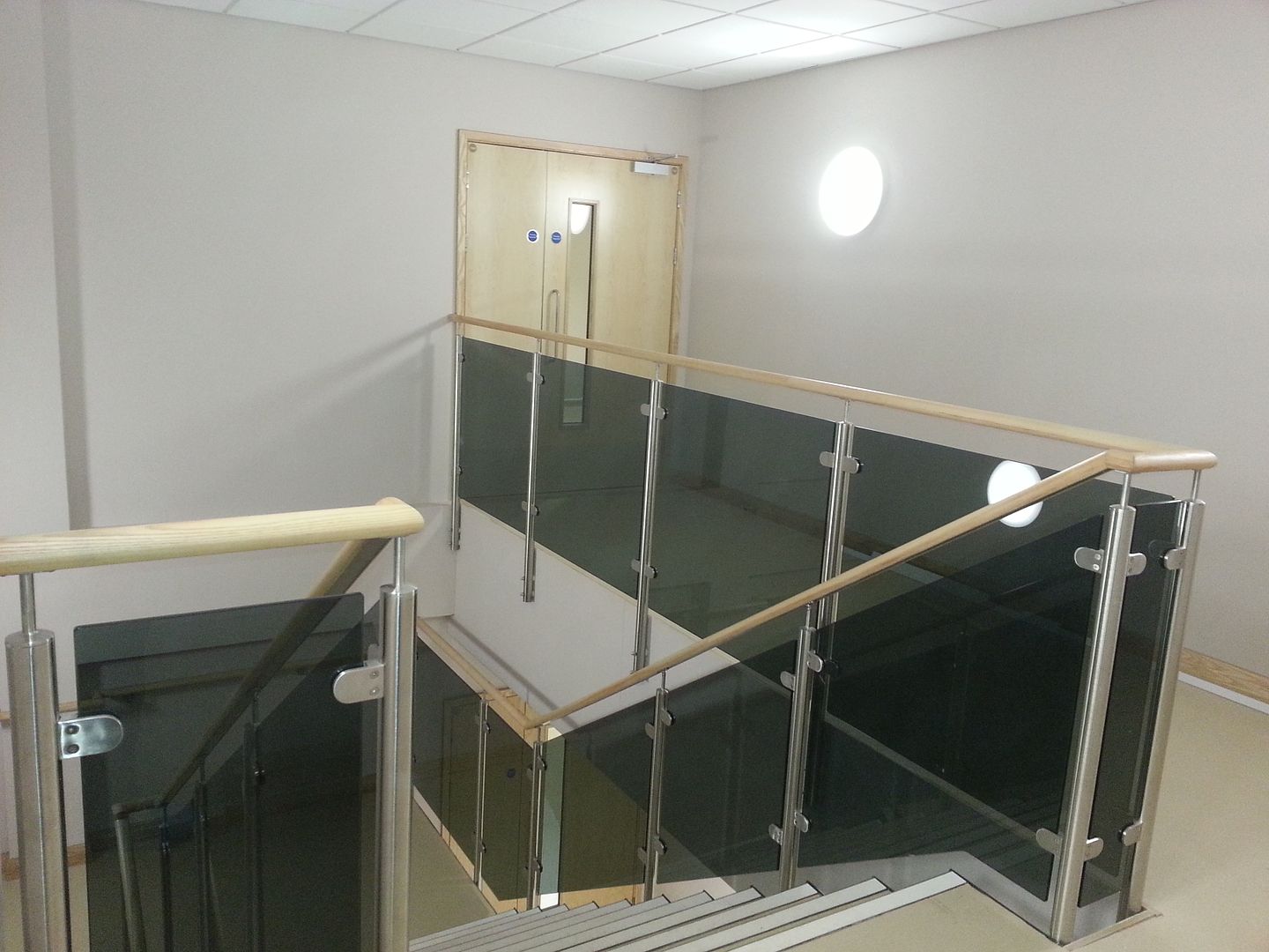 Glass balustrade leamington spa with timber handrail online uk installed
