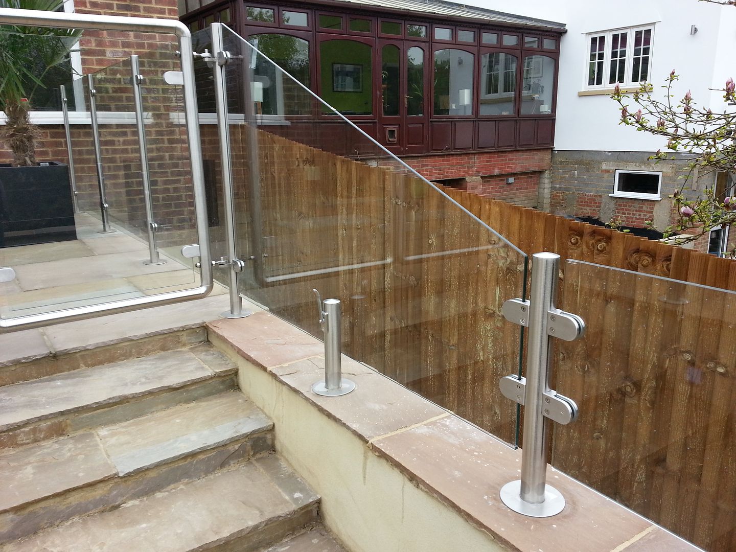 Clear glass balcony balustrade with hinged gates access