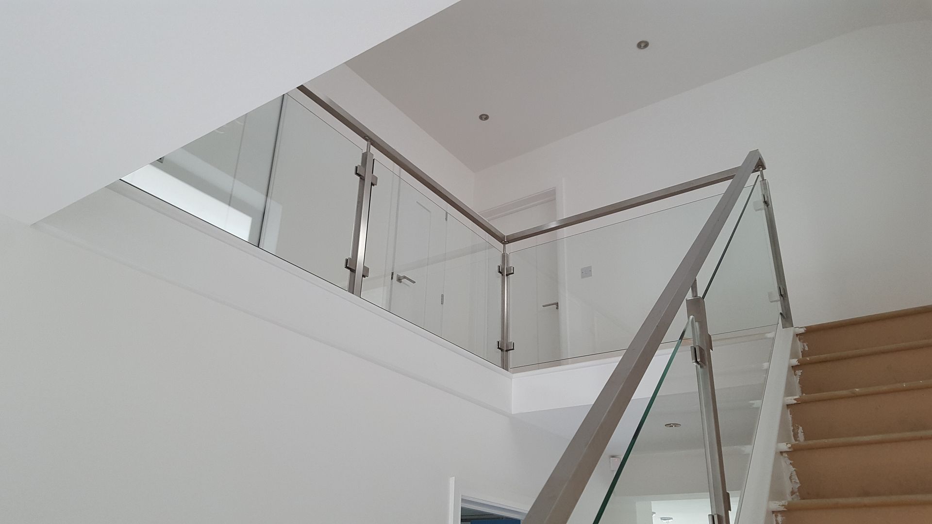 Square line stainless steel and glass balustrade design uk