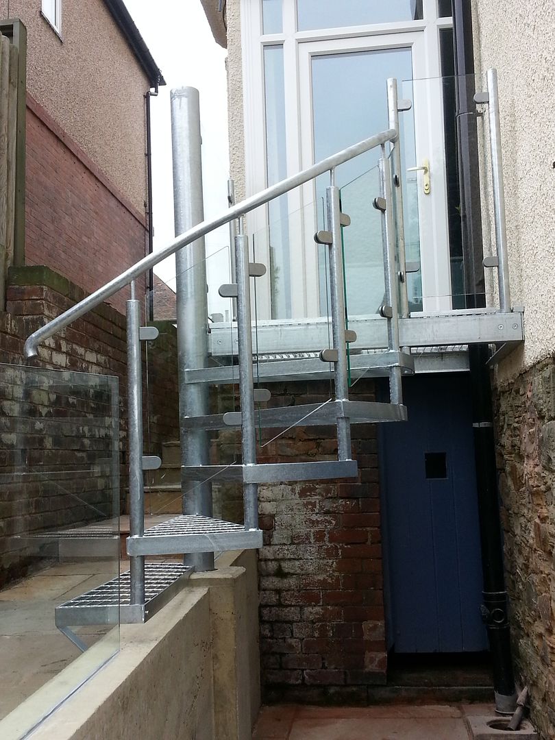 Structural glass balustrade and galvanized spiral staircase