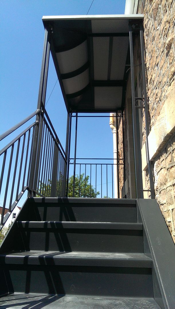 Metal staircase with overhead zinc clad canopy detail uk