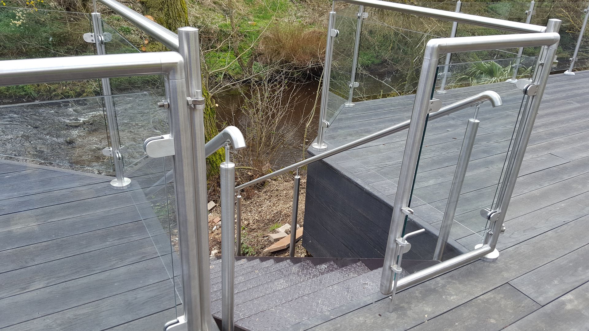 Stainless steel glass hinged gates to patio balustrade by DioMet