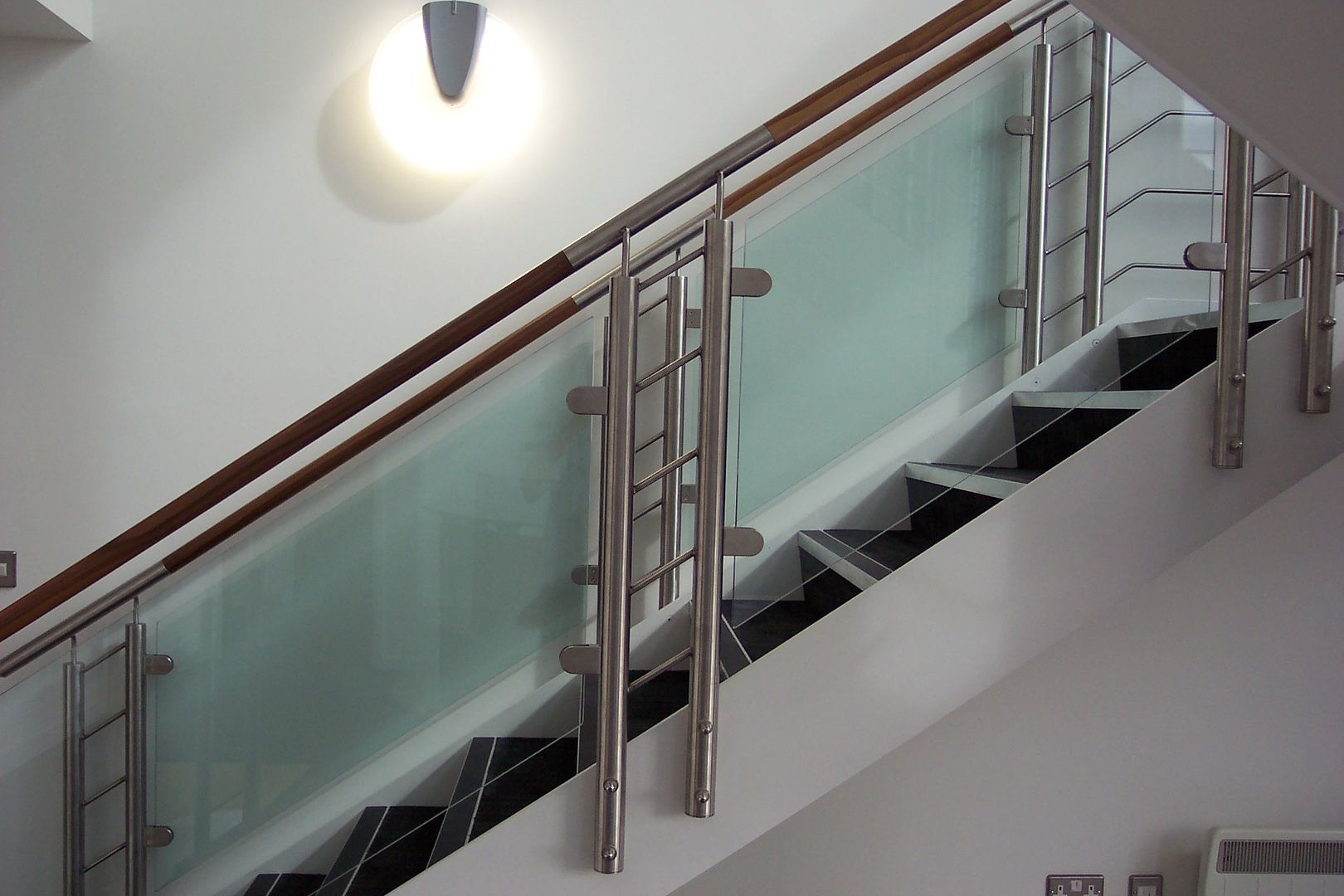 staircase with timber handrail and glass online