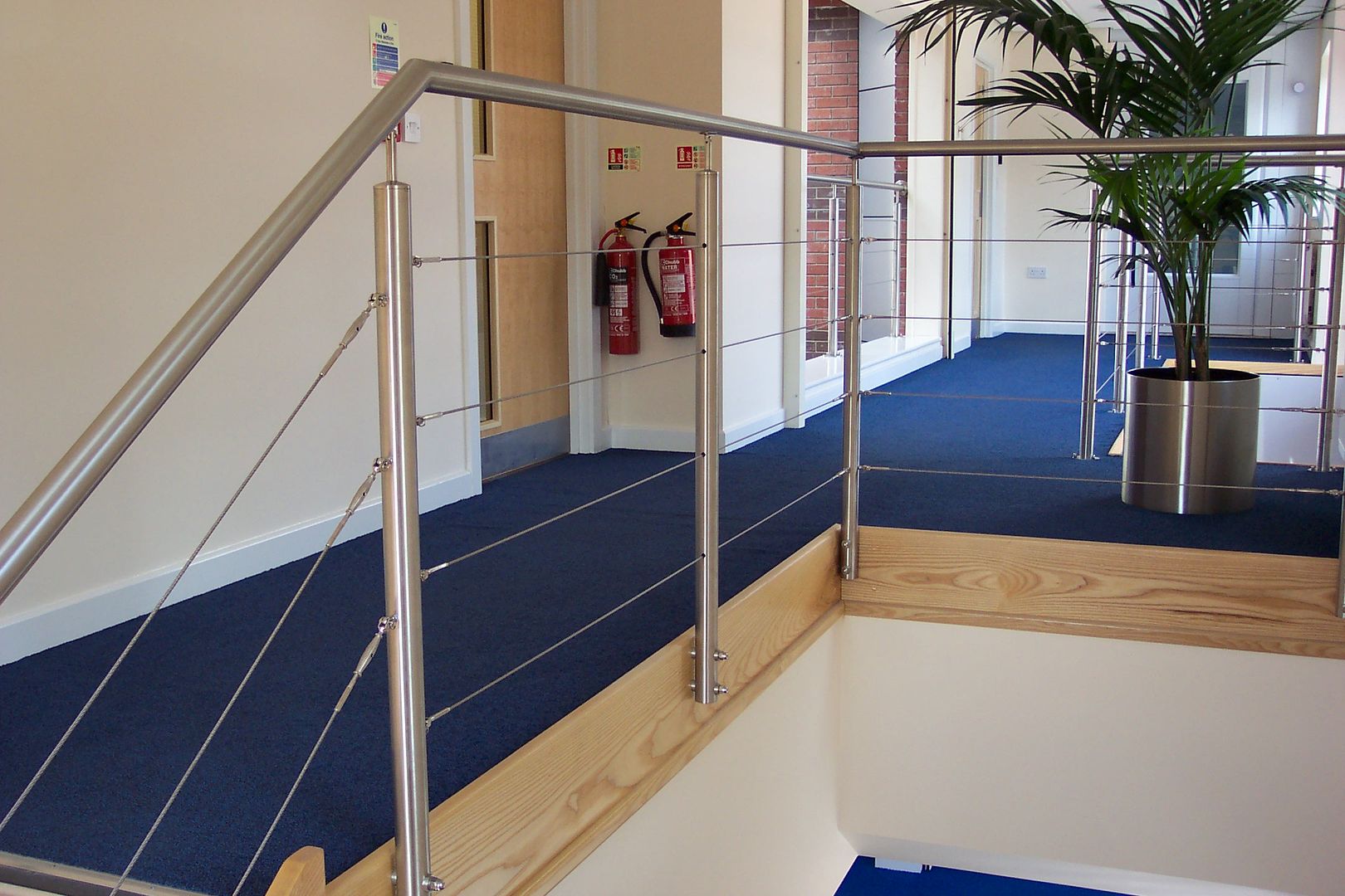 Stainless steel balustrade with wire infills and tubular posts
