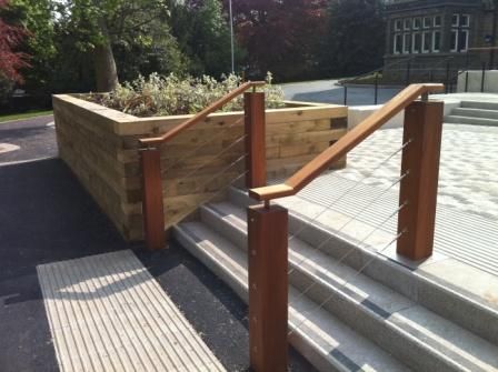 Iroko timber posts and handrail with stainless steel wire rope infills