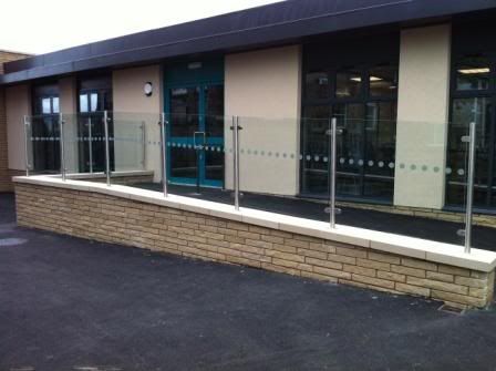Glass balustrade with stainless steel baluster posts. 